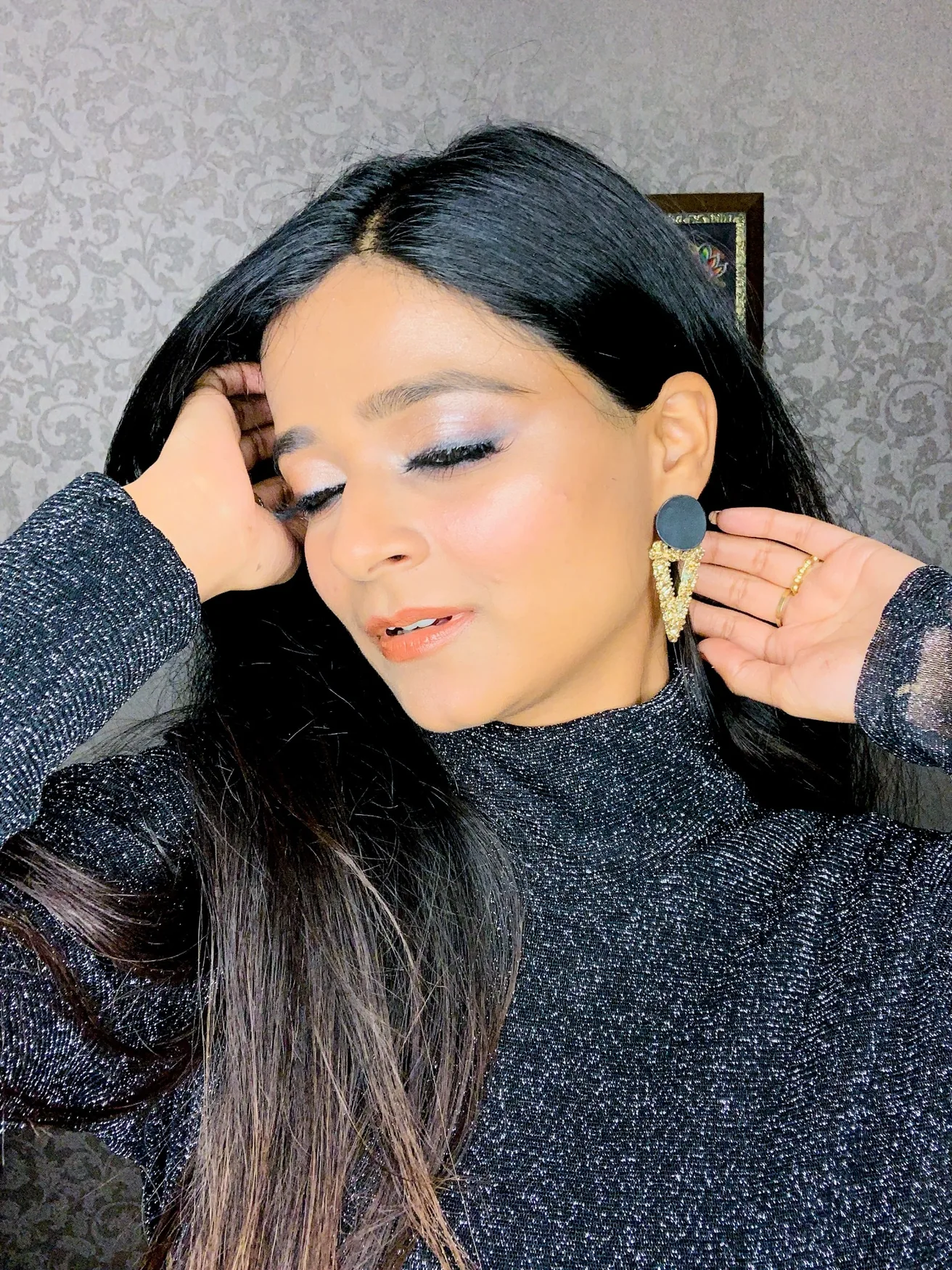 Lavanya wearing a shimmery black outfit and statement earrings