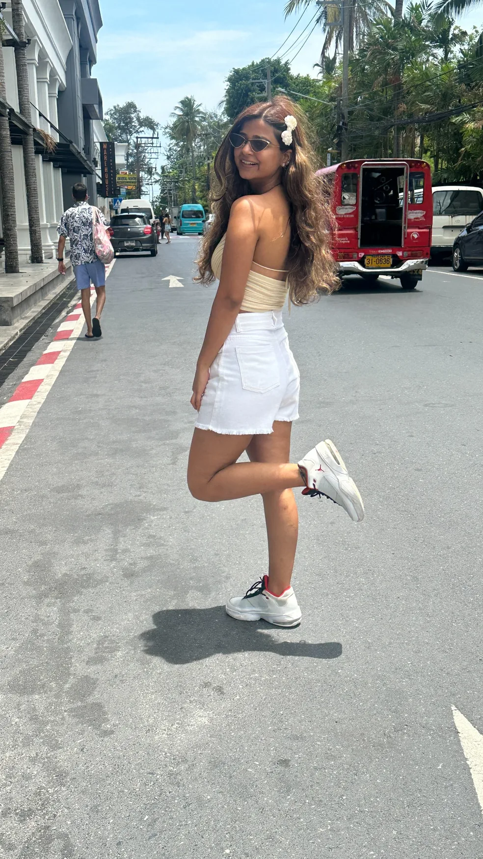Lavanya smiling on a sunny city street